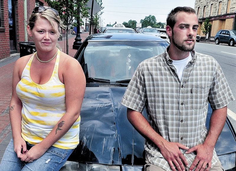 WILD FOURTH OF JULY: Christina Tirrell and Lucas Drinkwater beside Tirrell’s vehicle on Monday that she says was hit by a truck after the West Athens Fourth of July parade last week. Drinkwater said he was beaten and injured in a fight after the accident.