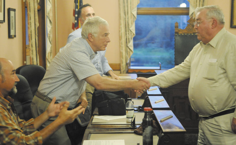 Peter Prescott, right, thanks Hallowell tax incremental finance committee member Joel Davis after meeting with the group Tuesday about Prescott’s request that the city reduce taxes for a proposed ice arena he wants to build in the city to replace the Kennebec Ice Arena, which collapsed last winter. City Councilors Stephen Vellani, left, and Edmund J. Cervone also serve on the committee.