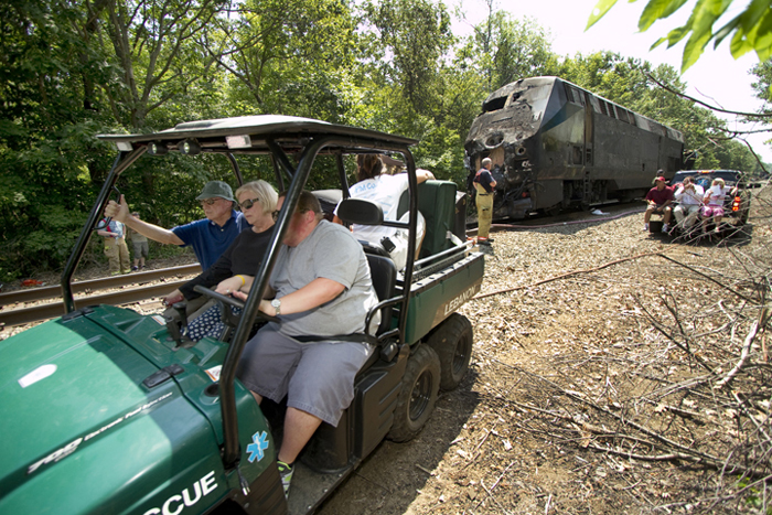 A rescue vehicle carries Downeaster passengers away from the scene of the collision.