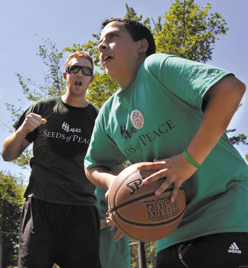 ALL RIGHT: Brian Scalabrine of Chicago Bulls cheers on Jabra, a Seeds of Peace International camper from Palestine on Thursday.