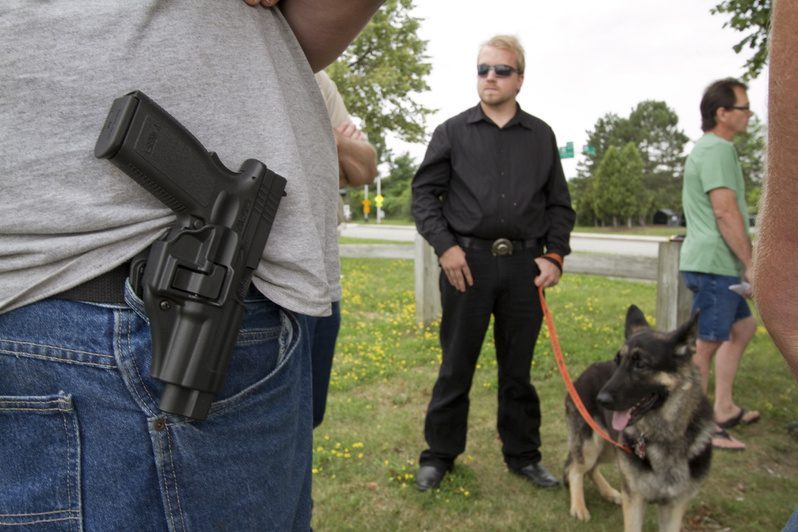 Supporters of the Maine Open Carry Association gather near Back Cove in Portland today to show support for the right to carry holstered firearms in public.