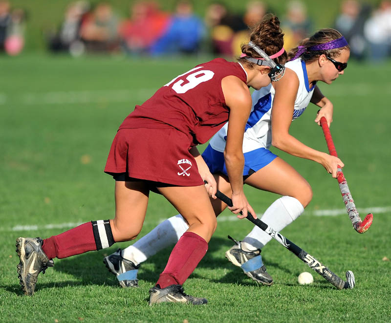 Staff photo by Michael G. Seamans Lawrence High School's Danielle Armour, 4, right, battles for the ball with edward Little High School's Kayla Nadeau, 19, in the second half of Eastern A quarterfinals game at Lawrence High School in Fairfield Tuesday. Lawrence defeated Edward Little 2-0.