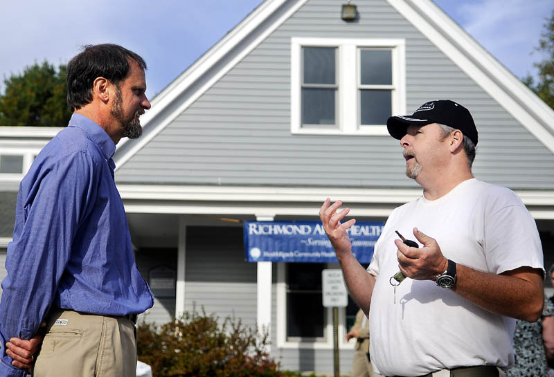 HUGE LOSS TO THE COMMUNITY: Nurse practitioner Tom Bartol, left, confers Tuesday with patient Jeff Dugas outside the Richmond Area Health Center following a celebration of weight loss by patients. About 700 area patients lost a total of 4,500 pounds, according to Bartol, who organized the program. Dugas said he lost more than 40 pounds.