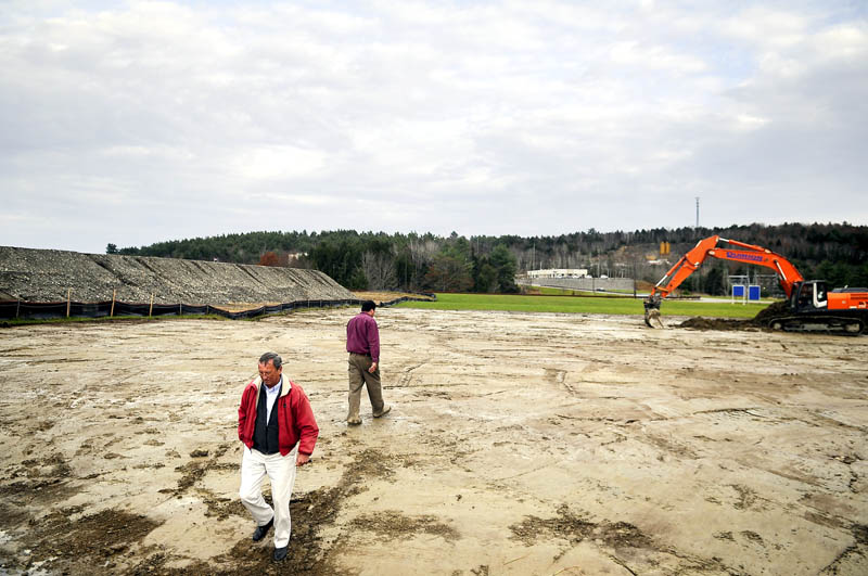 Peter Quirion, right, returns to his excavator Tuesday after speaking with Mattson Development chief operating officer Bill Dowling on the spot where the firm is laying out a parking lot for a 110,000 sq. ft. office it is building at the Commerce Center in Augusta. Construction will commence over the next few weeks on the new building that will house the State of Maine's Office of Information Technology and Maine Revenue Service, according to Dowling. Quirion Construction is doing earth work at the site.