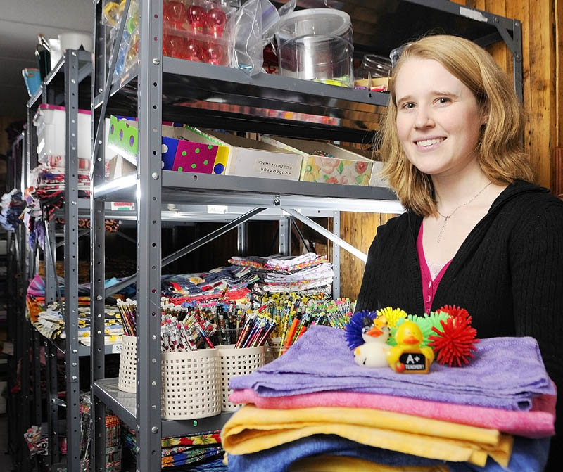 SUPPLIES: Syntiro employee Jenny Hartung poses with some of the decorations and other items the company uses for conferences.