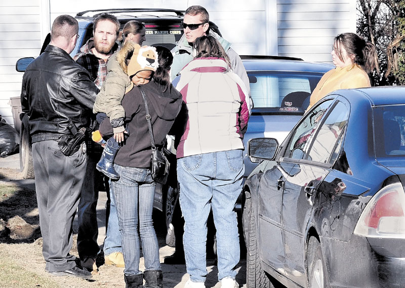 LOOKING FOR ANSWERS: Maine State Police Detective Christopher Tupper, left, talks to Justin DiPietro after he arrived at his home on Violette Avenue in Waterville on Sunday as an extensive search was under way at his home and the neighborhood for Ayla Reynolds, his 20-month-old daughter. She has been missing since Friday.