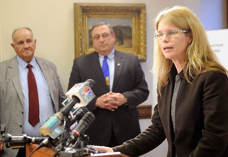 H. Sawin Millett, Jr. Commissioner, Department of Administrative & Financial Services, left and Gov. Paul LePage listen as Mary Mayhew, Commissioner: Department of Health & Human Services speaks during a news conference to announce changes to the MaineCare system on Tuesday in the State House's Cabinet Room in Augusta.