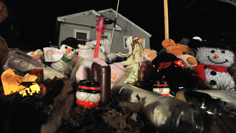 A teddy bear shrine sits outside the Violette Avenue residence of Ayla Reynolds in Waterville Thursday night.