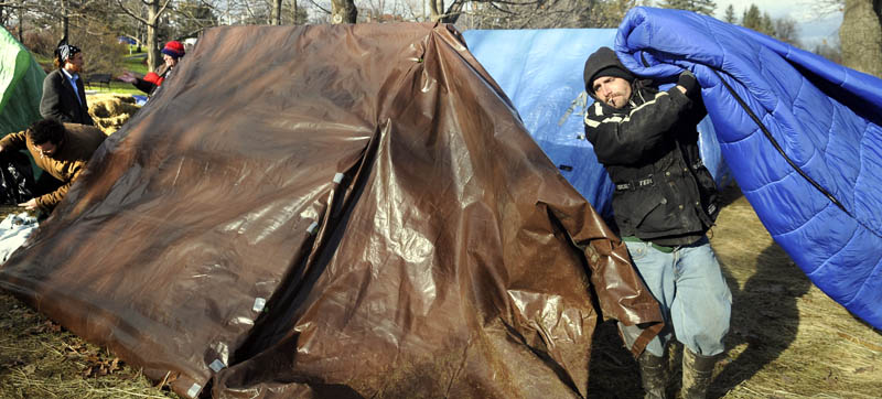 Participants in the Occupy Augusta movement remove bedding Thursday from shelters in Capitol Park in Augusta. Protesters broke camp after a federal judge said they needed a permit to stay in the park. The group objects to a permit because it says the protest should be considered free speech and not subject to regulation. Police told Occupy Augusta to have all the structures removed by the end of business Thursday and the park cleaned up by this morning.