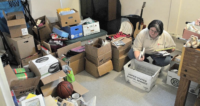 Salvation Army Capt. Wendy Morrison sorts through donated toys on Wednesday afternoon in the agency's building at 11 N. Pearl Street.