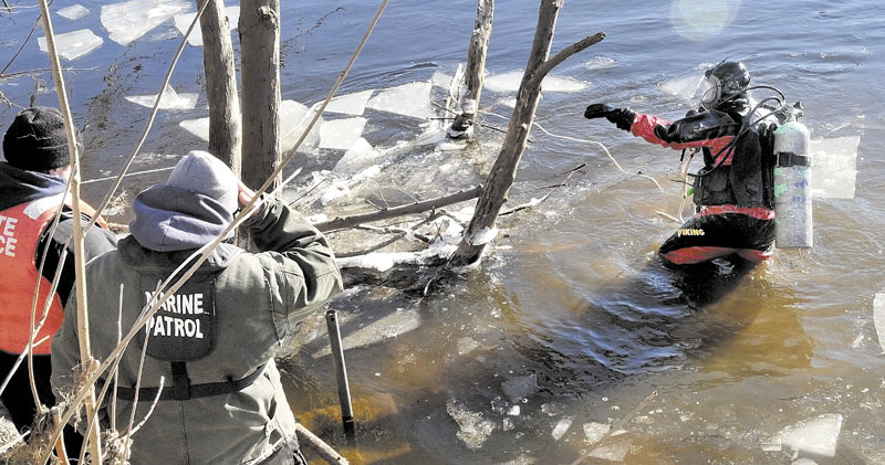 HARD SEARCH: Maine State Police diver Jarod Stedman encountered sunken wood and floating pieces of ice while searching underwater for signs of missing toddler Ayla Reynolds in the Kennebec River near the boat launch off Water Street in Waterville on Wednesday.