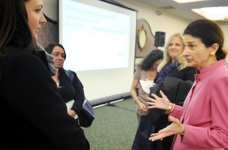 U.S. Senator Olympia Snowe, R-Maine, right, confers Tuesday with Laura Kibort, left, during an Augusta forum held by Facebook to assist small business to utilize the social networking site. Kibort is the event manager of the Royal Oak Room in Lewiston.