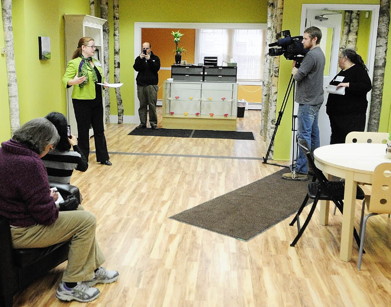 Executive Director Becky DeKeuster speaks during a Tuesday news conference at the Wellness Connection of Maine dispensary in Hallowell. The medicine is stored in and dispensed from the cupboards behind the counter.