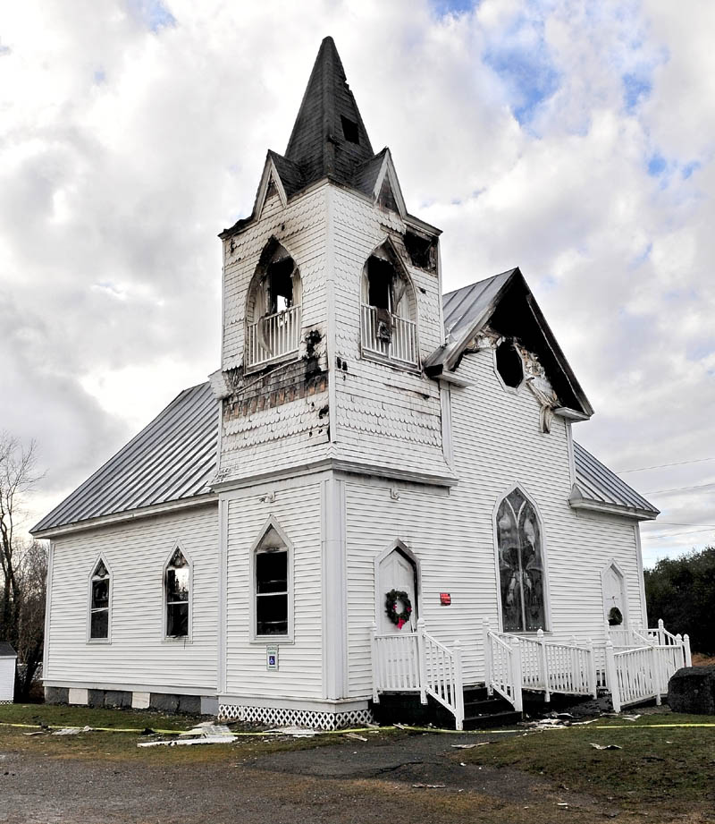 UNCERTAIN: The remains of the Thorndike Congregational Church stands on Monday after being gutted by fire on Dec. 28. According to Deaconess Patty Banker the congregation is in favor of rebuilding the century-old church but a decision has not been made on a date. Banker said church services will continue every Sunday at Clyde and Hazel Rumney’s home at 42 Palmer Road in Thorndike at 10 a.m.