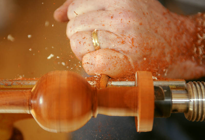 Dr. Kieran Kammerer turns a rattler from compressed blocks of Padauk and Maple wood at his Hallowell shop.