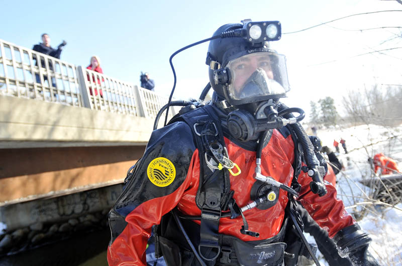 Trooper Dan Worcester exits Messalonskee Stream next to North Street bridge in Waterville Friday. Dive teams from the Maine Warden Service and Maine State Police Friday resumed searching for clues to the disappearance of 22-month-old Ayla Reynolds.