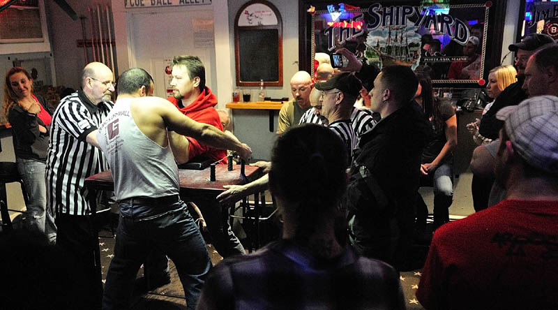 David Goulet, of Bangor, left, and Kurt Howgate, of Shapleigh, get ready to compete in the Maine State Arm Wrestling Championships on Saturday night at the Pond Town Tavern in Winthrop.