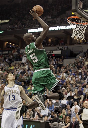 Boston Celtics forward Kevin Garnett (5) makes a one-handed dunk over Minnesota Timberwolves guard Luke Ridnour (13) during the third quarter of an NBA basketball game on Friday, March 30, 2012, in Minneapolis. The Celtics won 100-79. (AP Photo/Genevieve Ross)