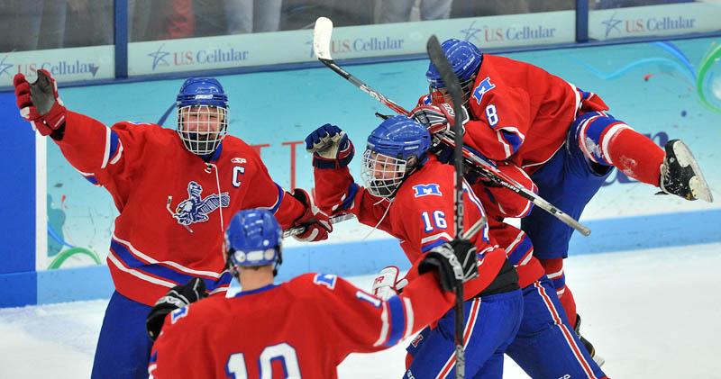 Photo by Michael G. Seamans Messalonskee High School celebrates an open net goal with 41 seconds left in the third period of the Class B East hockey regional finals at Alfond Arena at the University of Maine in Orono Tuesday night. Messalonskee defeated Brewer 5-2.