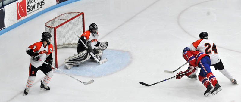 Photo by Michael G. Seamans Messalonskee High School's Sam Dexter, 7, far right, gets tangled up with Brewer High School's Jake Caron, 24, in the second period of the Class B East hockey regional finals at Alfond Arena at the University of Maine in Orono Tuesday night.