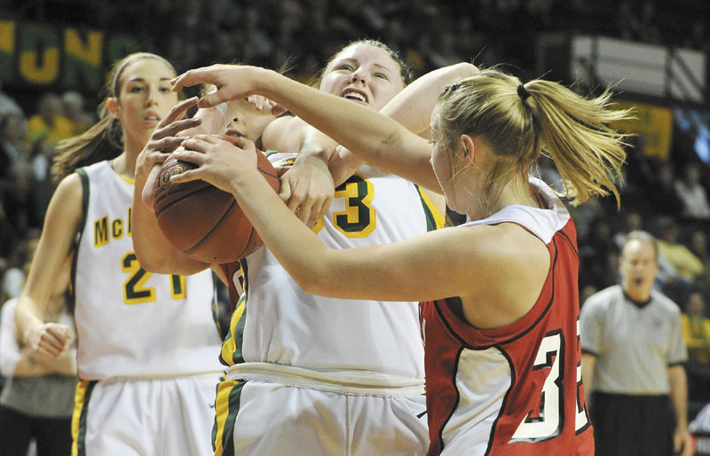 John Ewing/Staff Photographer... Saturday, March 3, 2012...McAuley vs. Cony girls class A state championship game. McAuley's Victoria Lux battles with Cony's #32, Amelia Diplock, during rebounding action.