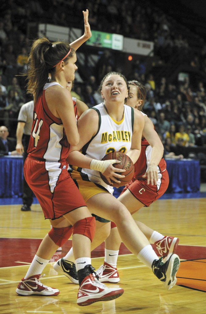 John Ewing/Staff Photographer... Saturday, March 3, 2012....McAuley's Victoria Lux starts her move to the basket against Cony's #34, Melanie Guzman.