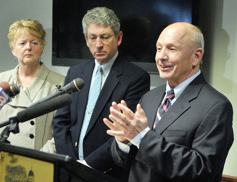 Westbrook Mayor Colleen Hilton, left, and Augusta Mayor William Stokes, listen as Portland Mayor Michael Brennan, right, speaks during a news conference at the State House on Thursday in Augusta.