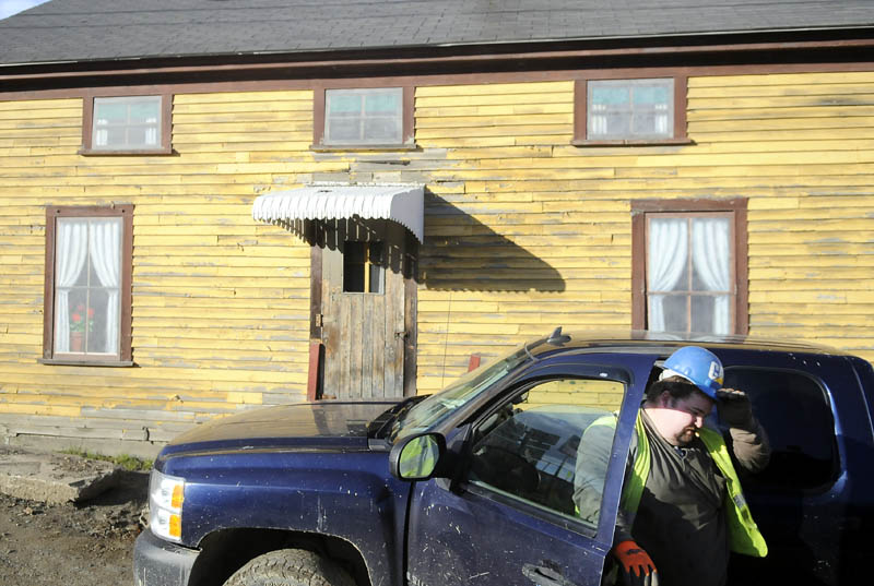 Contractor Doug Grant climbs out his pick up Tuesday in front of 25 Bond Street in Augusta. The City of Augusta must decide what to do with the building that it owns. Grant was working on a nearby utility project.