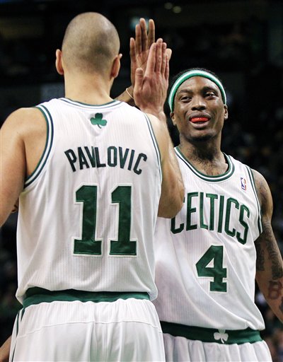 Boston Celtics guard Marquis Daniels (4) celebrates with forward Sasha Pavlovic (11) during the second half against the Miami Heat in an NBA basketball game in Boston, Tuesday, April 24, 2012. The Celtics won 78-66. (AP Photo/Elise Amendola)