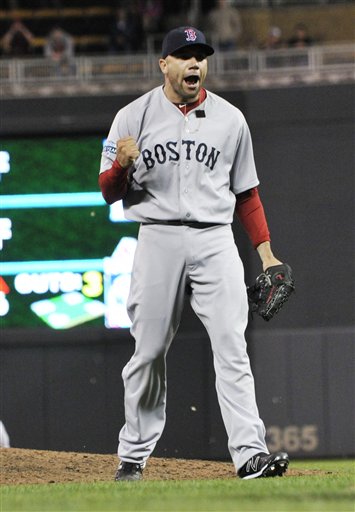 Boston Red Sox pitcher Alfredo Aceves celebrates the Red Sox's 7-6 win over the Minnesota Twins in a baseball game Wednesday, April 25, 2012, in Minneapolis. The Red Sox swept the three-game series. Aceves picked up the save. (AP Photo/Jim Mone)