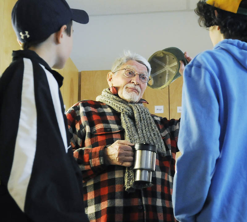 Dan Sorensen, 85, and Maranacook Community Middle School seventh graders Andrew Coulombe, left, and Logan McLaughlin chat Monday during a meeting at the new Senior Center at the Readfield school.