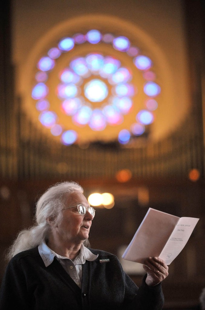 Staff Photo by Michael G. Seamans Shyla Spear prays during Good Friday Mass at Sacred Heart Church in Waterville. The Holy Trinity Anglican Church rents space at Sacred Heart Church.