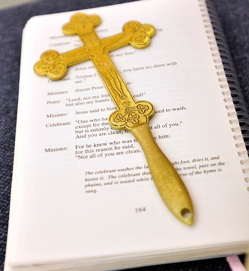 Staff Photo by Michael G. Seamans Father Larry's crucifix during the Holy Thursday service at St. Joseph's Maronite Church in Waterville Thursday evening. In the Holy Thursday service, Father Larry Jensen washed the feet of some parishiners as did Jesus and his disciples before the Last Supper.