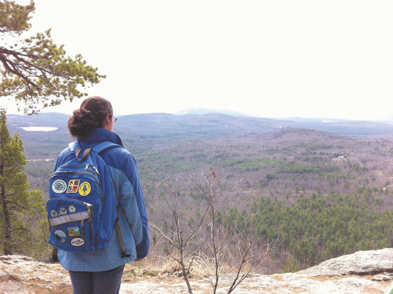 ENJOYING THE VIEW: A young hiker enjoys the reward of getting to the top of Sabattus Mountain in Lovell. From the trailhead it’s a 1.5-mile loop, with an elevation gain of about 500 feet.