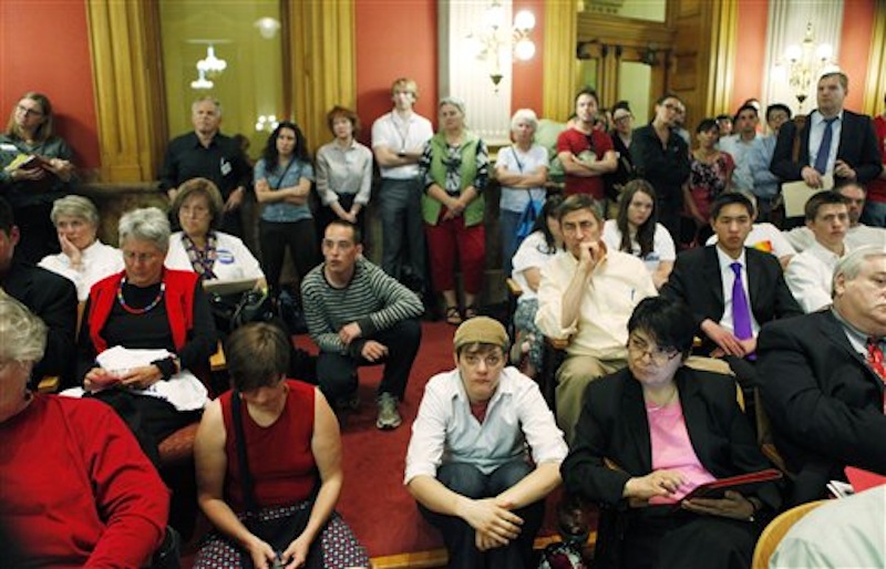 An overflow crowd listens as House Minority Leader Mark Ferrandino, sponsor of the Civil Unions bill, testifies before the House State Affairs Committee at the state Capitol in Denver on Monday, May 14, 2012. Gov. John Hickenlooper called the special session for lawmakers to vote on Civil Unions and other issues not completed when last weeks general session ended. (AP Photo/Ed Andrieski)