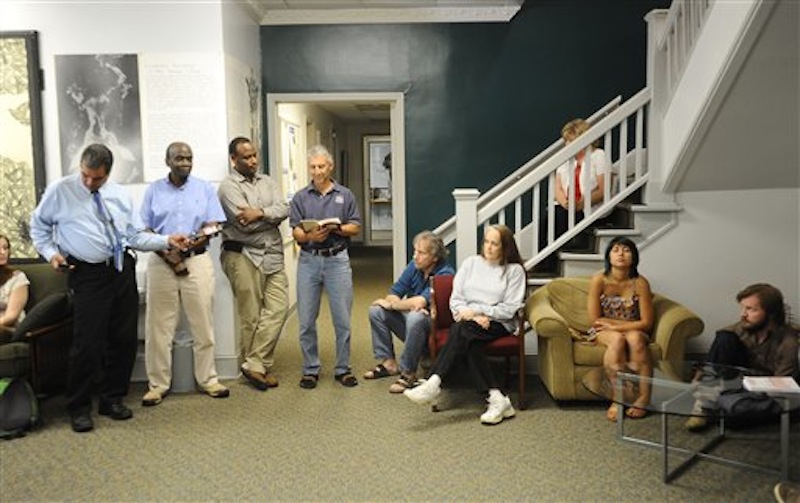 University of West Georgia psychology professor Dr. Tobin Hall, fourth from right, reads from Rumi at a vigil for University of West Georgia student Aimee Copeland Thursday, May 10, 2012 in Melson Hall on the campus of the University of West Georgia in Carrollton, Ga. Doctors say Copeland, who is fighting a flesh-decaying bacteria she contracted after a zip line accident, will lose her hands and remaining foot to the infection. (AP Photo/Times-Georgian, Cliff Williams)