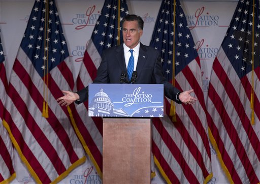 In this May 23, 2012, photo, Republican presidential candidate Mitt Romney gestures during a speech at the Latino Coalition annual economic summit at the U.S. Chamber of Commerce in Washington. Government spending and debt are emerging as a campaign tug-of-war. Romney blames President Barack Obama for a "prairie fire of debt." Obama calls the charge a "cowpie of distortion." Both candidates are reaching for unaligned, independent voters anxious about who's going to get stuck with the bill. (AP Photo/Evan Vucci)