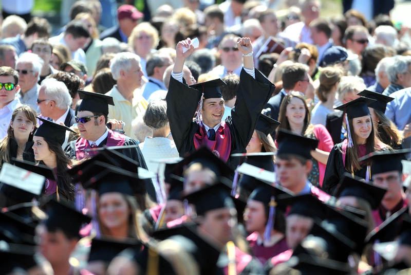 Staff Photo by Michael G. Seamans A happy UMF graduate waves to family and friends as graduates and faculty take their seats for Commencement ceremonies at University of Maine at Farmington Saturday.