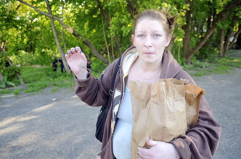 Amanda Bechard, 26, chats with journalists on Thursday afternoon while authorities investigate explosives found in an apartment on Gage Street in Augusta.