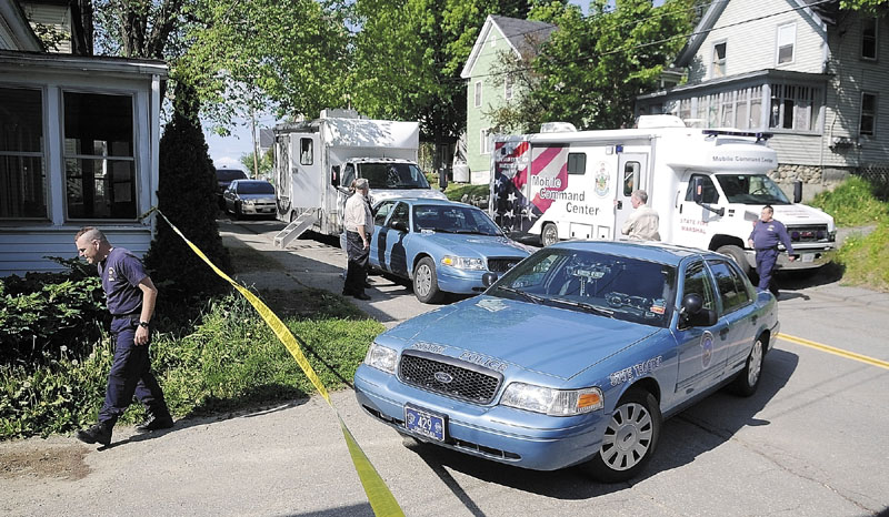 Police vehicles block Gage Street in Augusta on Thursday afternoon while authorities investigate explosives found in an apartment.