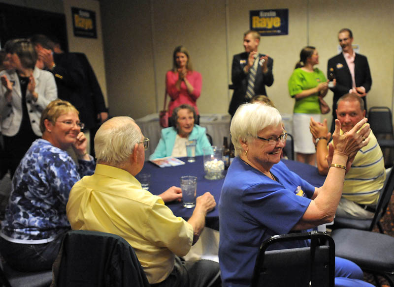 Staff photo by Michael G. Seamans Suppoerters cheer for Kevin Raye, candidate for US second congressional district, as poll numbers roll in at the Ramada Inn in Bangor Tuesday night.