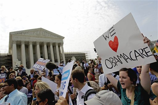 FILE - In this June 28, 2012 file photo, supporters of President Barack Obama's health care law celebrate outside the Supreme Court in Washington. It looks like a tax, smells like a tax, and the Supreme Court says it must be a tax. But politicians in both parties are squirming over how to define the Thing in President Barack Obama's health care law that requires people to pay up if they don't get health insurance. The problem for Obama is that, if the Thing is indeed a tax, he is by definition a raiser of taxes on the middle class, which he promised not to be. If that sounds like an opportunity for Republican presidential rival Mitt Romney, well, it's not that simple. (AP Photo/David Goldman, File)