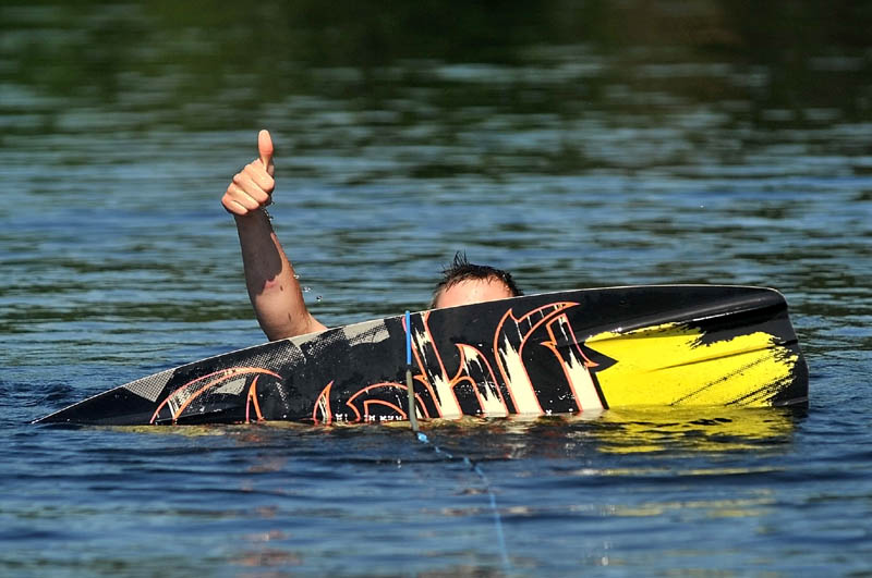 Staff Photo by Michael G. Seamans Jeb Charette, of Winslow, gives the thumbs-up to Troy Welch at the controls of the boat on his first time wake boarding on Messalonskee Lake in Oakland Friday morning.