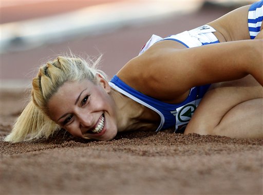 Greece's Voula Papachristou lands in the sand after her jump at the Women's Triple Jump final at the European Athletics Championships in Helsinki, Finland in June. The Hellenic Olympic Committee has removed Papachristou from Greece's 2012 Olympic team over comments she made on twitter making fun of African immigrants and expressing support for a far-right party. For better and for worse, the 2012 Olympics are being shaped, shaken and indisputably changed by social media sites such as Twitter, whose immediacy and public nature has added a new and chaotic element to the Games. The Associated Press photo