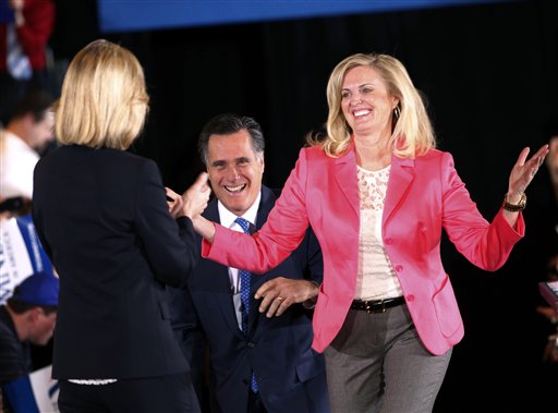 FILE - In this March 6, 2012, file photo, Republican presidential candidate, former Massachusetts Gov. Mitt Romney, and his wife Ann arrive on stage as they are greeted by former Mass. Lt. Gov. Kerry Healey, at their Super Tuesday primary watch party in Boston. To the yearbook editors at the all-girl Kingswood School, Ann Lois Davies' destiny seemed pretty obvious. "The first lady," the entry beside the stunning blond beauty's photo in the 1967 edition of "Woodwinds" concluded. "Quiet and soft spoken." The modern feminist movement was just dawning, and even some of the girls at the staid prep school in the wealthy Detroit suburb of Bloomfield Hills were feeling their oats _ if in a somewhat tame way. Charlon McMath Hibbard remembers getting a doctor's note about her feet, so she wouldn't have to wear the obligatory saddle Oxfords. (AP Photo/Gerald Herbert, File)