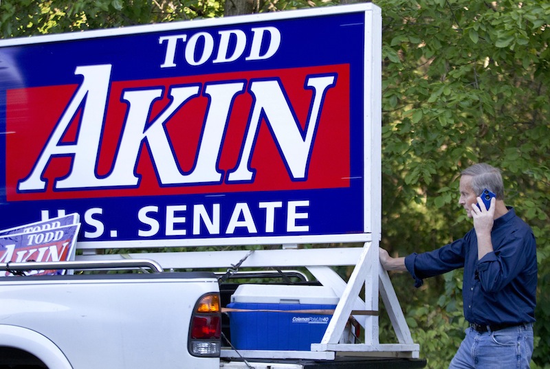 Senate candidate Rep. Todd Akin, R-Mo., talks on the phone before campaigning at the Northwest Missouri State Fair in Bethany, Mo., Thursday, Aug. 30, 2012. It was Akin's first public interaction with voters since his Aug. 19 comment in a TV interview that women's bodies have ways of averting pregnancy from what he called "legitimate rape." The comment prompted widespread backlash, with some Republicans urging him to quit the race against Democratic Sen. Claire McCaskill. (AP Photo/Orlin Wagner)