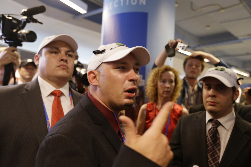 Ron Paul supporter Bryan Daugherty of Bangor protests in the walkway Tuesday after many Maine delegates walked out of the GOP convention.