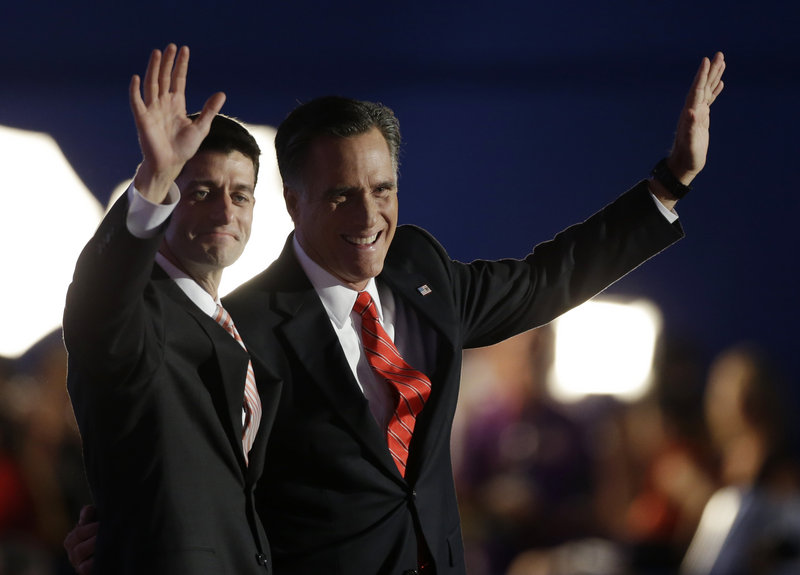 Republican vice presidential nominee Paul Ryan, left, and presidential nominee Mitt Romney acknowledge the applause after Romney’s speech. President Obama’s promises “gave way to disappointment and division. This isn’t something we have to accept,” Romney said.