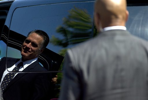 Secret Service agents stand guard as Republican presidential candidate, former Massachusetts Gov. Mitt Romney walks to his car after services at the Church of Jesus Christ of Latter-day Saints on Sunday, Sept. 2, 2012 in Wofeboro, N.H. (AP Photo/Evan Vucci)