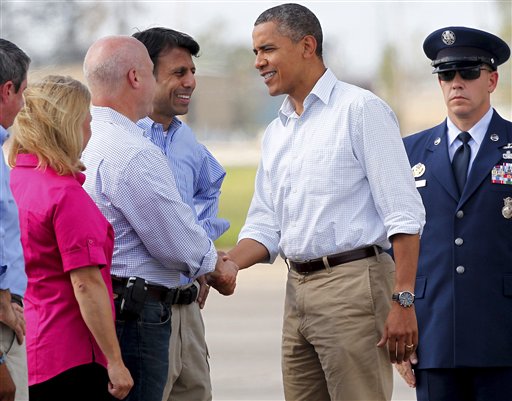 President Barack Obama greets New Orleans Mayor Mitch Landrieu, as Louisiana Gov. Bobby Jindal, center, and Sen. Mary Landrieu, D-La., watch in Kenner, La., on Monday.